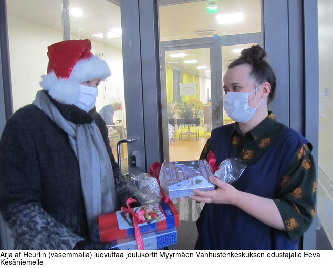 Arja af Heurlin (vasemmalla) luovuttaa joulukortit Myyrmen Vanhustenkeskuksen edustajalle Eeva Kesniemelle